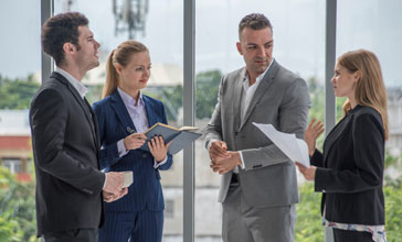 senior manager talking to two female colleagues