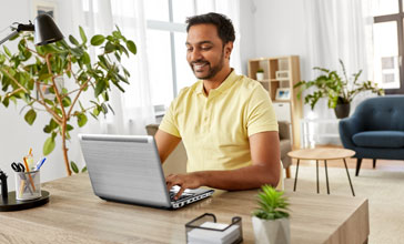 indian man with laptop working at home