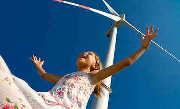 happy child near wind turbine