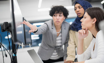 group of people reviewing results on screen