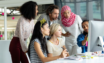group of young people working together in the office
