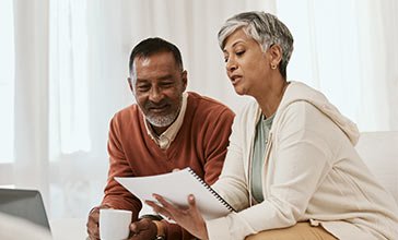 Senior couple looking at documents at home