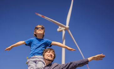 father and son outdoors new wind turbine