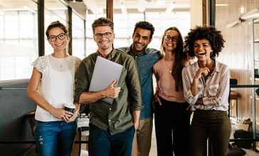 group of young people in the office smiling