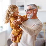 caring grandfather looking at his cute little granddaughter