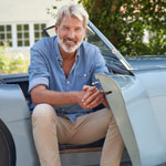 Mature man sitting in classic car