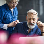 older couple working on laptop