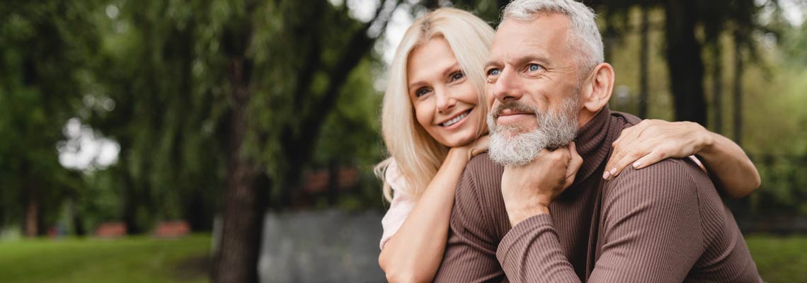 mature couple in the park cuddling
