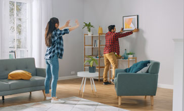 couple putting a picture up