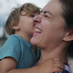 Mother holding her son and laughing
