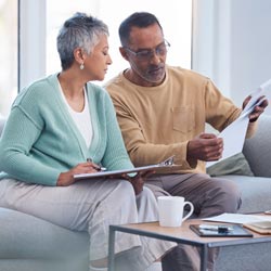 man and woman checking documents