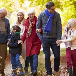 happy family walking through the park