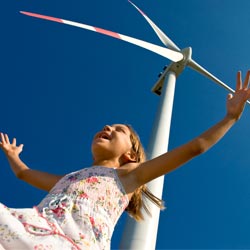 happy child near wind turbine