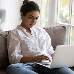 young woman using laptop at home