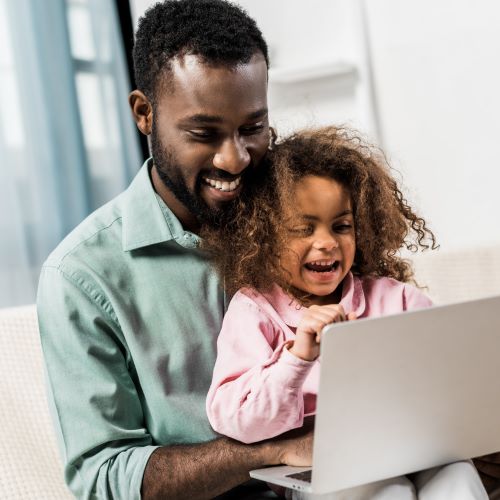 Father and daughter using a laptop