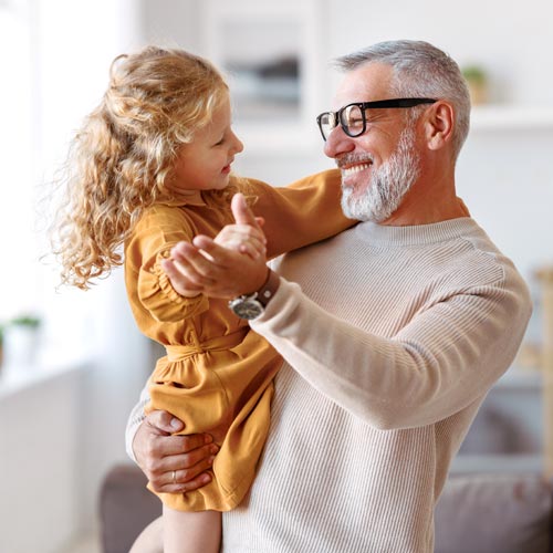 caring grandfather looking at his cute little granddaughter
