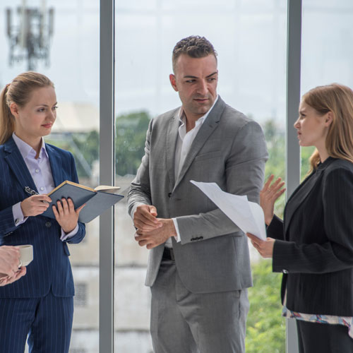 senior manager talking to two female colleagues