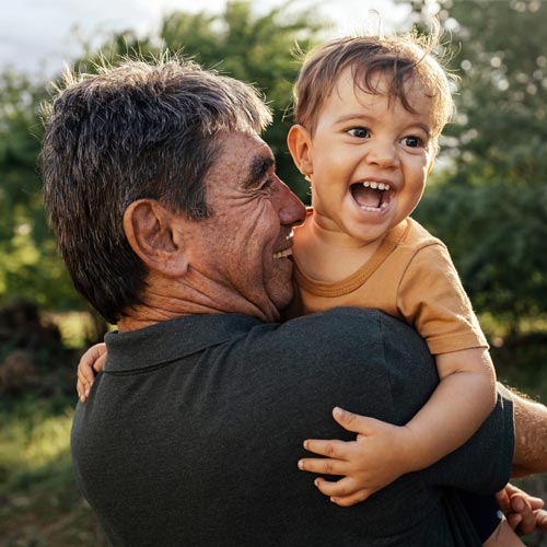 grandfather playing with his grandson outside