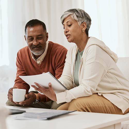 Senior couple looking at documents at home