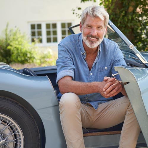 Mature man sitting in classic car