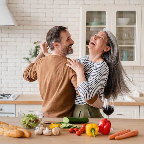 mature couple dancing in the kitchen