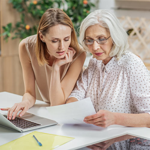 daughter checking documents with mature mum