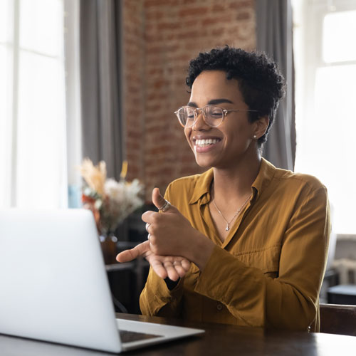 therapist in glasses talking on video call, using sign language