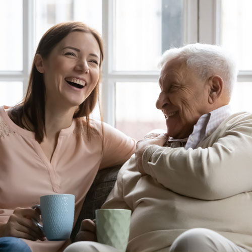 mature man having a tea with his daughter