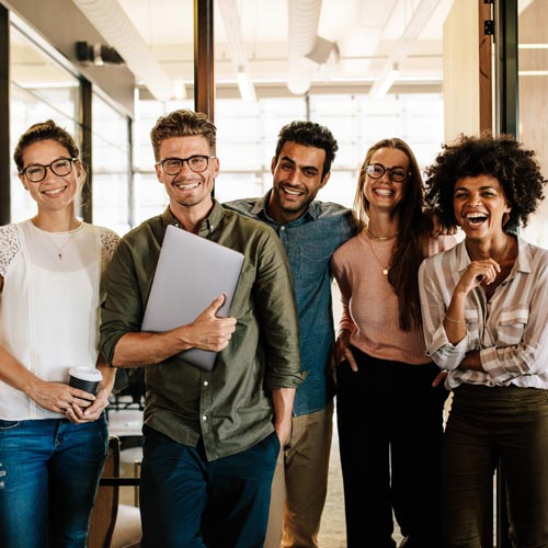 group of young people  in the office smiling