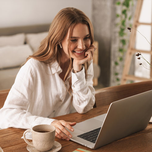 smiling woman using her laptop