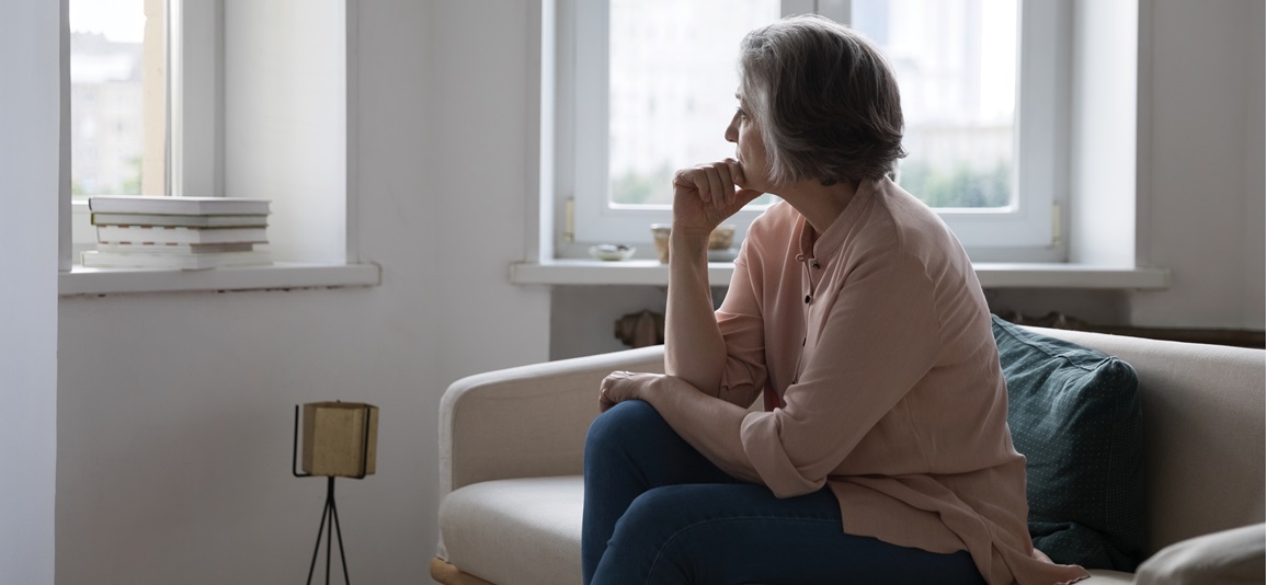 Stressed woman sat down looking out the window