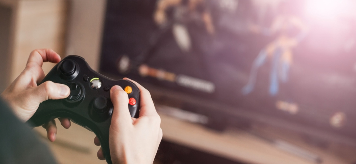 Person holding gaming controller