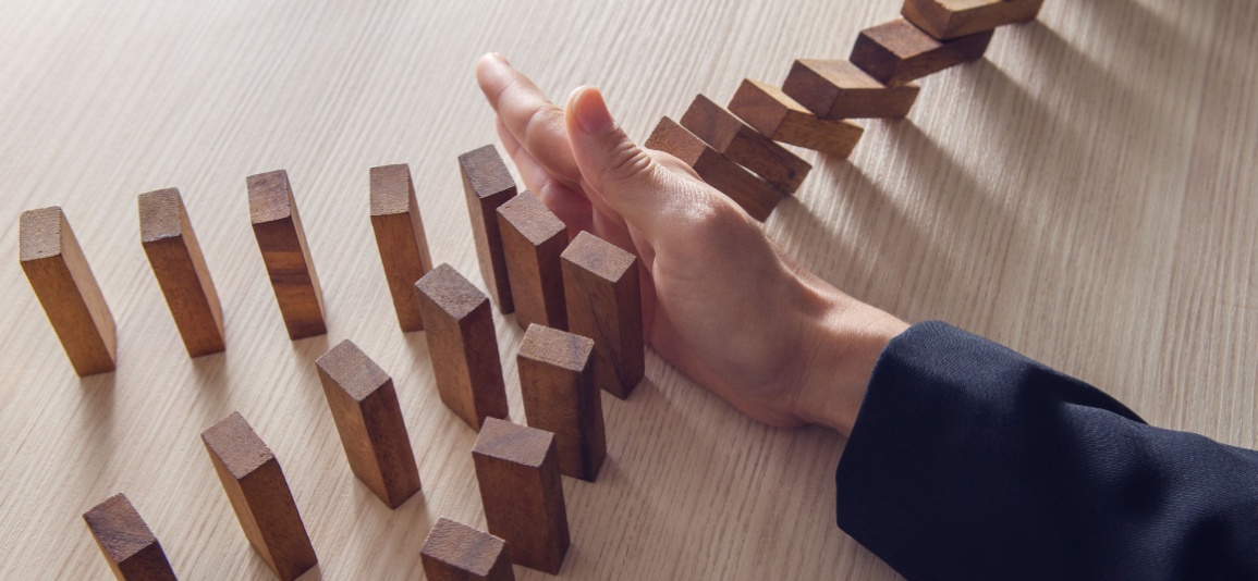 Person putting hand in front of falling blocks