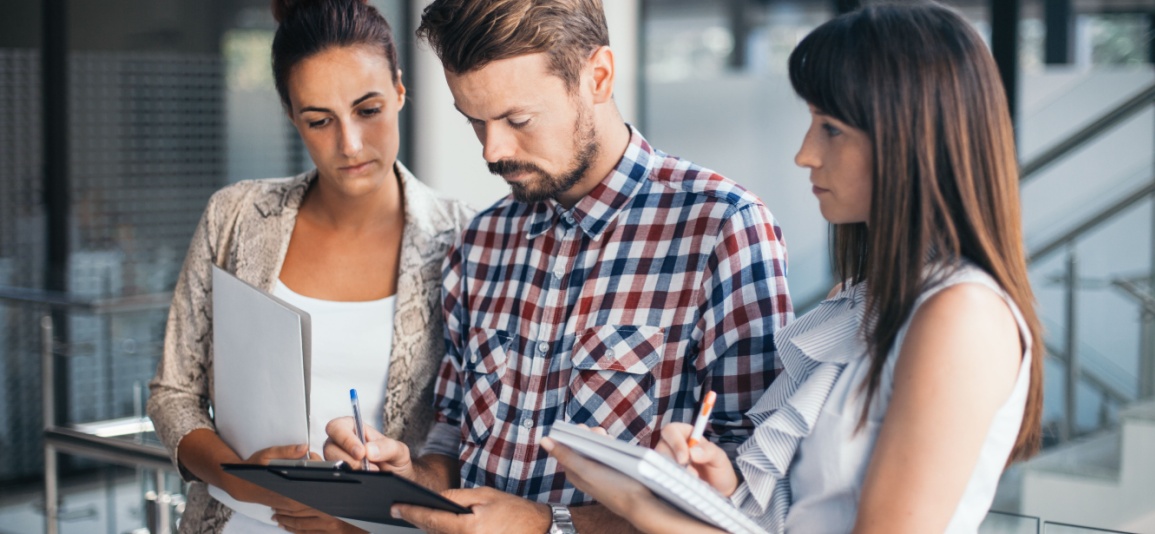 Business people having a discussion and look at a document