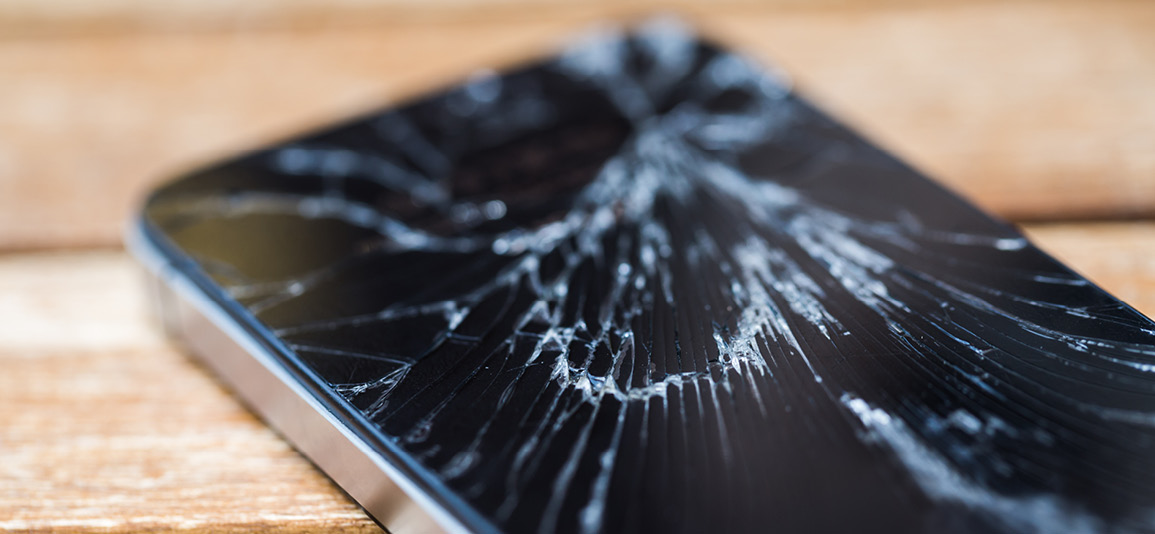 Broken glass of smart phone on the wood table