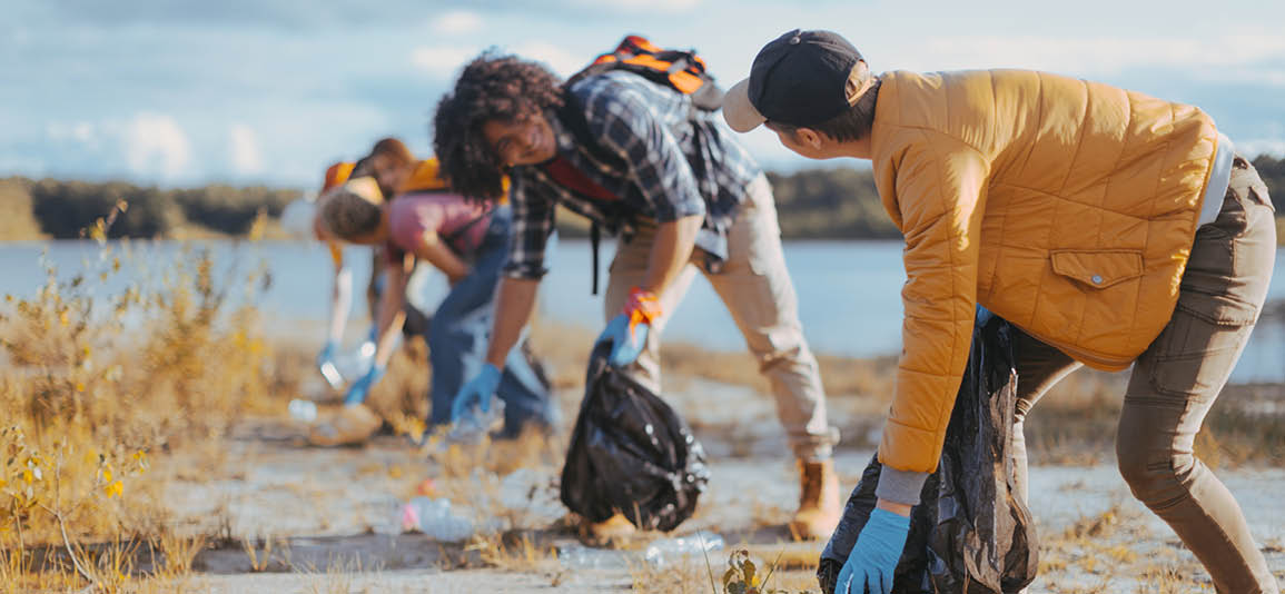 Group of volunteers helping clear up litter from a beach