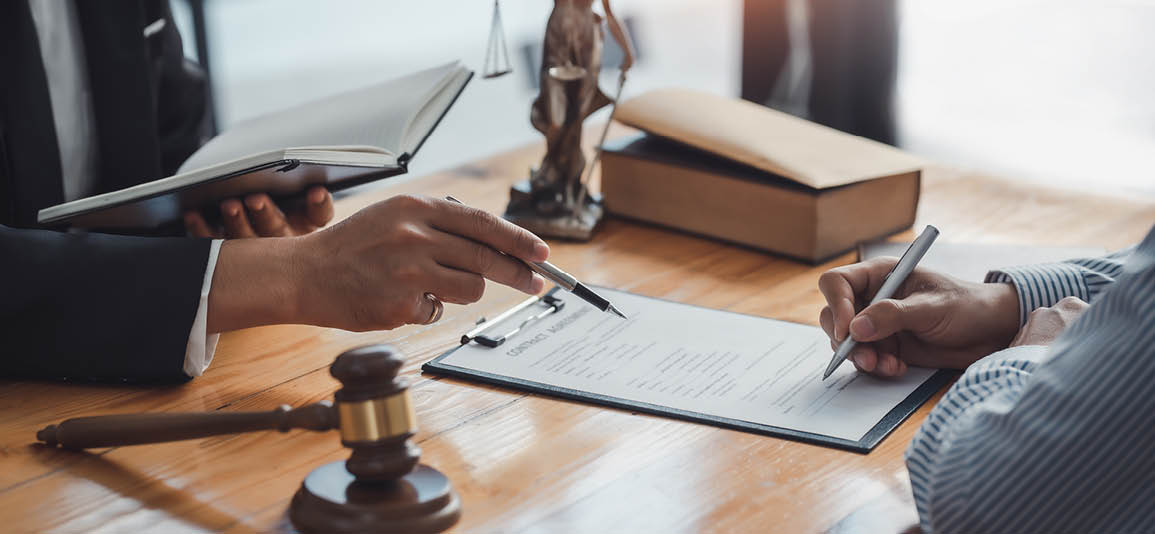 Desk with paperwork and lady justice statue on