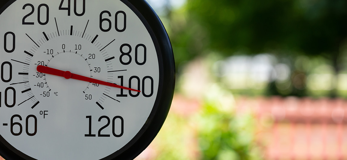 Outdoor thermometer in the shade during heatwave