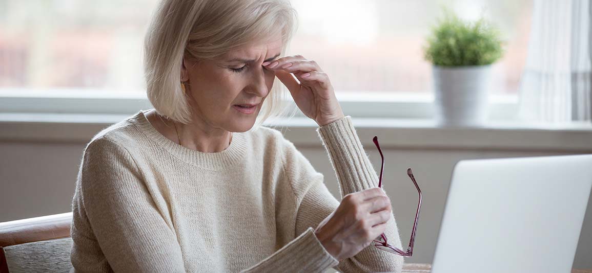 Woman stressed at laptop