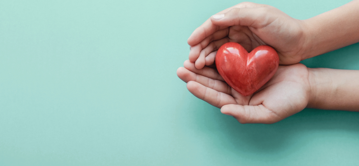 hands holding a red heart