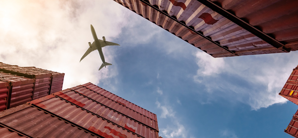 Airplane flying above container