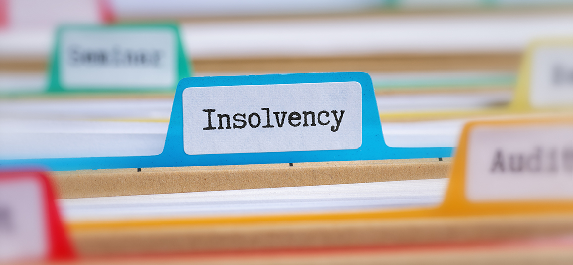 File folders with a tab labeled Insolvency