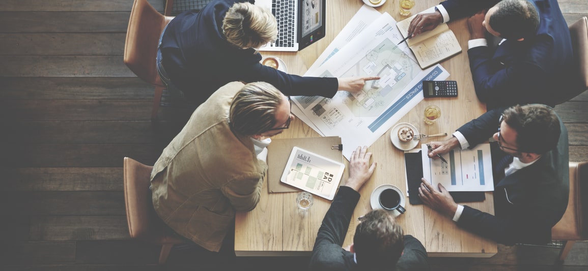 meeting around table to discuss research