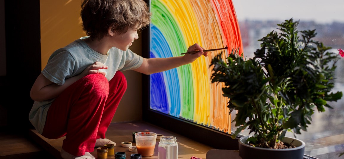 Boy painting a rainbow