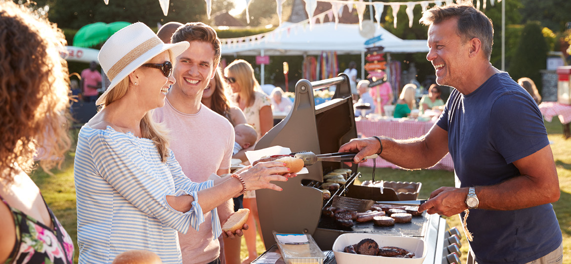 Group of people queuing at a BBQ