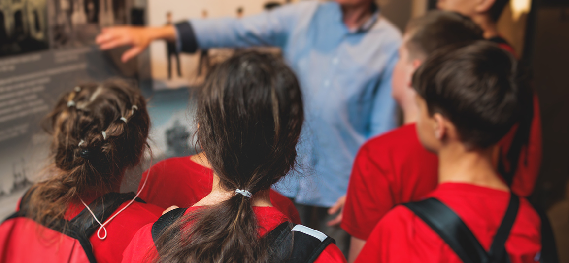 Group of students and school pupils in a science museum exhibition