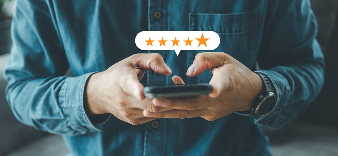 hand using smartphone with popup five star icon for feedback review
