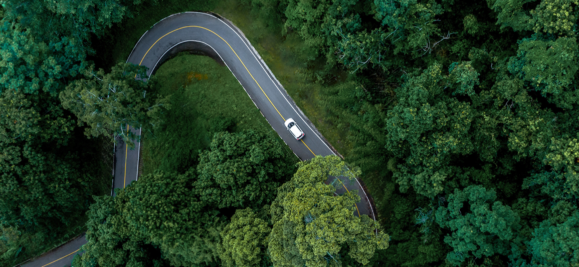 Aerial top view road in forest with car