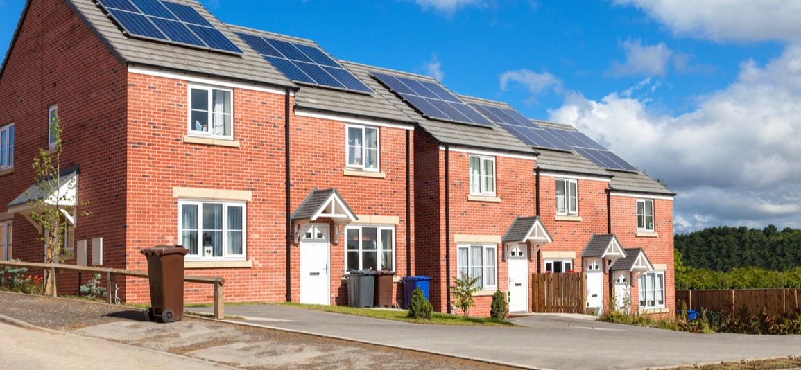 Row of red brick english houses with solar panels