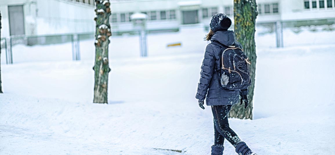 child walking through the snow